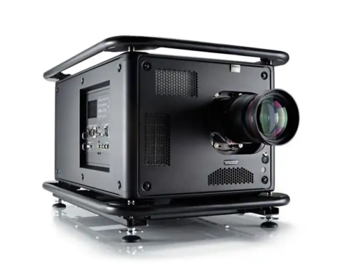 This image shows a high-performance black projector designed for professional use. It features a robust and industrial design with protective framing on the top and bottom. The projector has multiple ventilation grills for efficient cooling and a prominent, high-quality lens at the front for superior image projection. It includes various input/output ports on the side, suitable for advanced connectivity options. The projector is supported by adjustable feet, ensuring stability and proper alignment. The sleek, matte black finish emphasizes its professional and durable build.
