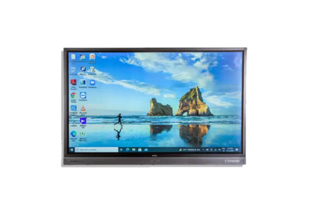 UHD monitor rental showing desktop with beach and rock formations wallpaper. Desktop icons and taskbar open, ready to go in a office or educational environment. Monitor shows off its high definition and clarity, perfect for presentations, video conferencing or interactive displays. Sleek design to fit any workspace.