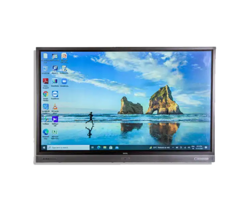 UHD monitor rental showing desktop with beach and rock formations wallpaper. Desktop icons and taskbar open, ready to go in a office or educational environment. Monitor shows off its high definition and clarity, perfect for presentations, video conferencing or interactive displays. Sleek design to fit any workspace.
