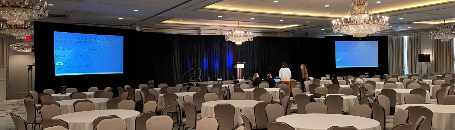 Indoor event setup in Atlanta with audio visual equipment, including cameras, screens, lighting, and staging for a professional presentation
