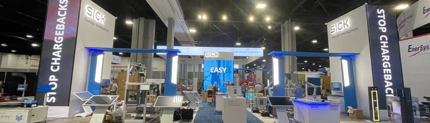 Indoor event setup in Atlanta with audio visual equipment, including cameras, screens, lighting, and staging for a professional presentation