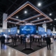 86-inch 4K monitors on rolling stands in a Las Vegas island booth