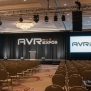 Corporate event audio setup with wireless microphones and speakers from AVR Expos.