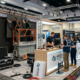 booth installation with crew and AV setup in progress