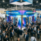 crowded trade show floor with booth capturing attention